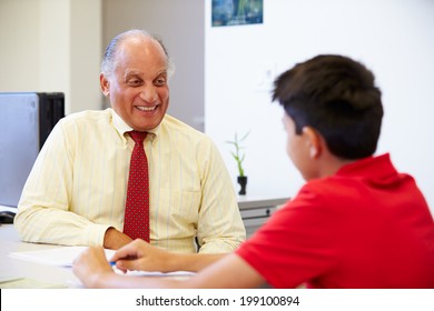 Male Student Talking To High School Counselor