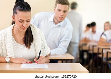 Male Student Trying To Cheat At Test In Class