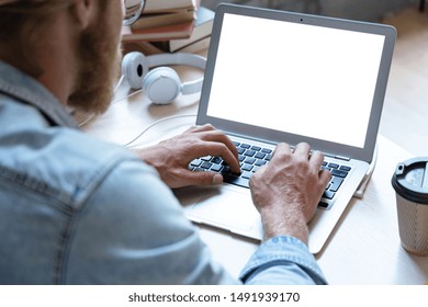 Male Student Using Laptop Software Looking At Empty White Mock Up Computer Screen Learn Easy Internet Course Study Online E Learning In App Type On Notebook At Table, Over Shoulder Close Up View