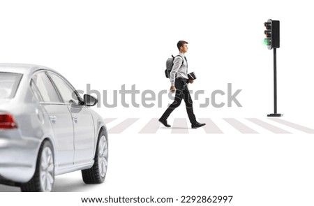 Male student walking at a pedestrian zebra crossing and car waiting at traffic lights isolated on white background