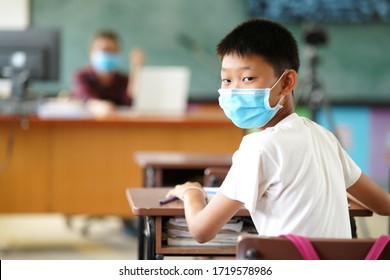 A Male Student Wearing A Mask Preventing The Outbreak Of Covid 19 In The Classroom