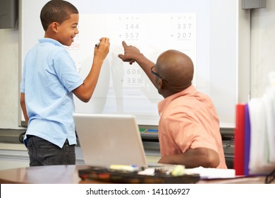 Male Student Writing Answer On Whiteboard - Powered by Shutterstock