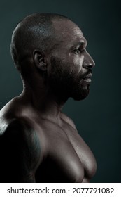 Male Studio Portrait Close-up. Swarthy Cuban Or Latino With Naked Muscular Body Looks Away. Side View In Profile. Brutal Face.