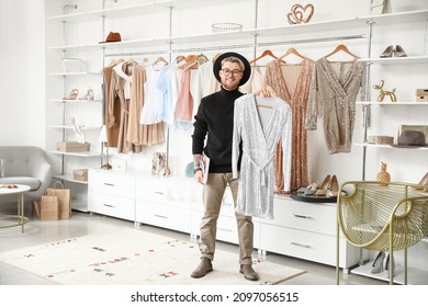 Male Stylist With Clothes In Studio