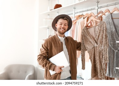 Male Stylist With Laptop Working In Studio