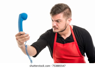 Male Supermarket Employer Looking Angry At Blue Phone Receiver Isolated On White Background