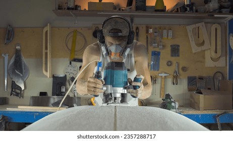 Male surfboard shaper making surfboard in his workshop. Hand shaping from blank. - Powered by Shutterstock