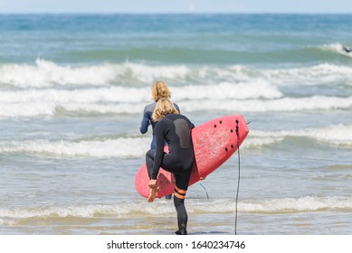 male surfer attaching his ankle leash - Powered by Shutterstock