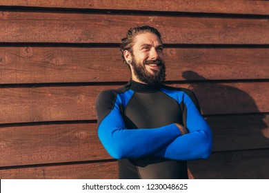 Male Surfer Lifestyle Portrait. Man In Wetsuit With Bodyboard Surfing Equipment