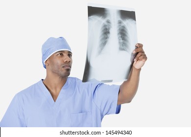 Male surgeon analyzing x-ray report over gray background - Powered by Shutterstock - Get 15% off with code: PIKWIZARD15