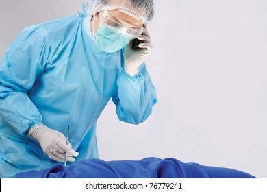 A male surgeon answering the phone - Powered by Shutterstock