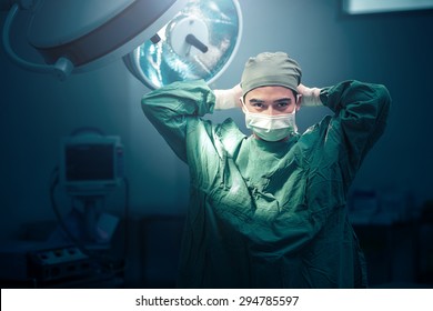 Male surgeon tying mask at operating room - Shutterstock ID 294785597