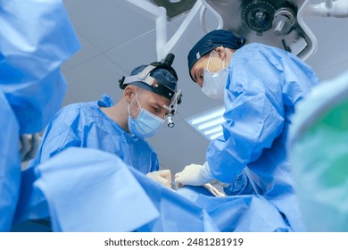 male surgeons perform surgery in operating room, plastic surgeon in operating room, A surgical team is carrying out an operation - Powered by Shutterstock