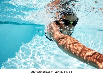 Male swimmer athlete swimming underwater in swimming pool - Powered by Shutterstock