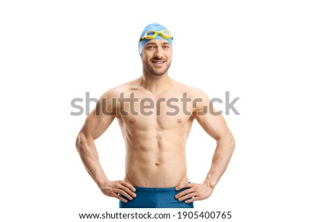 Male swimmer with googles and a cap posing isolated on white background