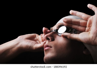 Male swimmer isolated on black - Powered by Shutterstock