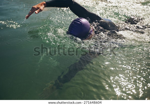 Male swimmer swimming in open water. Athlete\
practicing for the\
competition.
