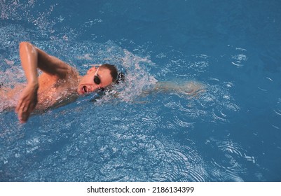 Male Swimmer At The Swimming Pool. Underwater Photo. Male Swimmer.