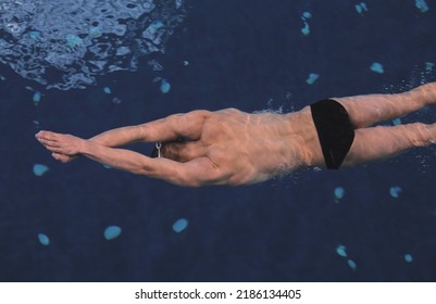 Male Swimmer At The Swimming Pool. Underwater Photo. Male Swimmer.