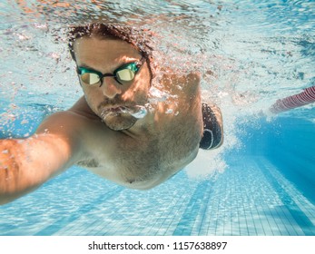 Male Swimmer In The Swimming Pool.Underwater Photo With Copy Space.