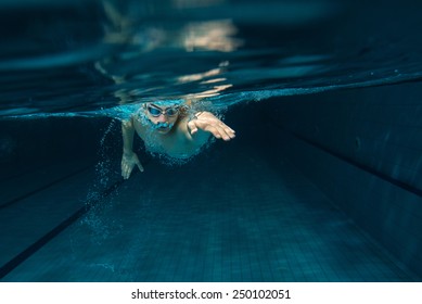 Male Swimmer At The Swimming Pool.Underwater Photo.