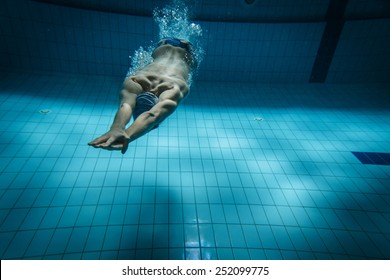 Male Swimmer At The Swimming Pool.Underwater Photo.