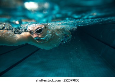 Male swimmer at the swimming pool.Underwater photo. - Powered by Shutterstock