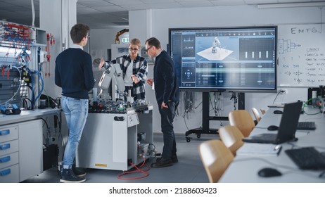 Male Teacher Attentively Listening to Opinions of His Smart Students During Lesson at University. People Discussing Robotic Prototype of Hand. Computer Science Education Concept. - Powered by Shutterstock