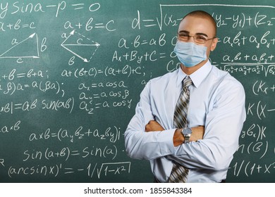 Male Teacher With Mask Teaching Math Lesson At School. Social Distanting And Classroom