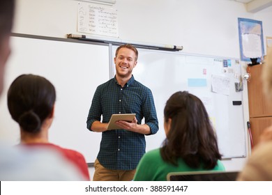 Male Teacher Using Tablet Computer At Adult Education Class