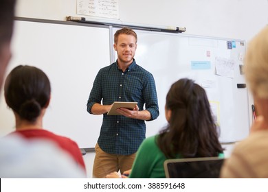 Male Teacher Using Tablet Computer At Adult Education Class