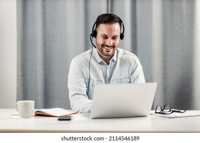 A Male Technical Support Agent Sitting At Home Office And Working From Home.