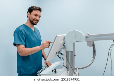 Male technician adjusts X-Ray machine. Male radiologist is going to take an Xray of patient in X-ray room of modern clinic. Medical examination of people. Modern medical equipment concept - Powered by Shutterstock