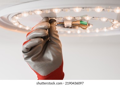 Male Technician Changing Light Equipment For More Energy Efficient