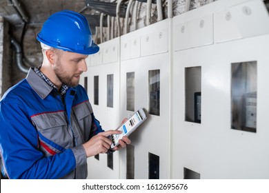 Male Technician Doing Meter Reading Using Tablet