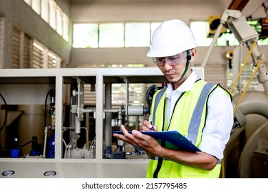 Male Technician Holding Clipboard While Examining Fusebox