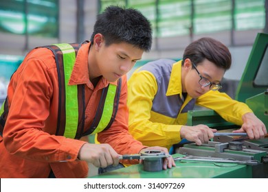 male technician machinist worker adjusting and repair machine in production line, factory concept
