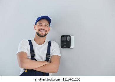 Male Technician Near Installed Alarm System Indoors