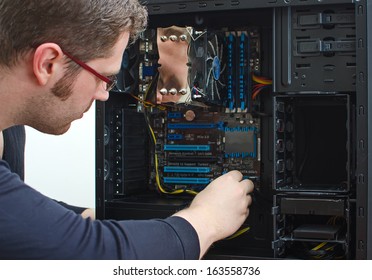 Male Technician Repairing Computer At Store