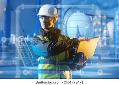 Male technologist at chemical plant. Engineer stands with laptop near factory. Manufacturing technologist. Technologist near tanks with cryogenic liquid. Factory contractor in uniform - Powered by Shutterstock