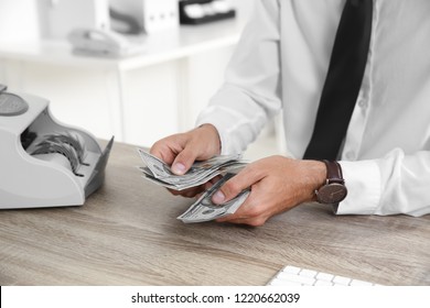 Male Teller Counting Money At Cash Department, Closeup