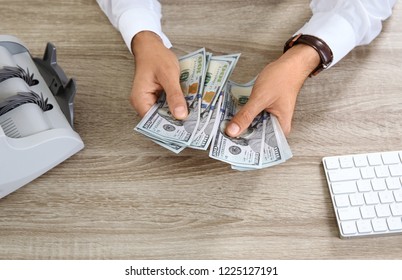 Male Teller Counting Money At Cash Department, Closeup