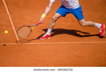 Male tennis player in action on the court on a sunny day