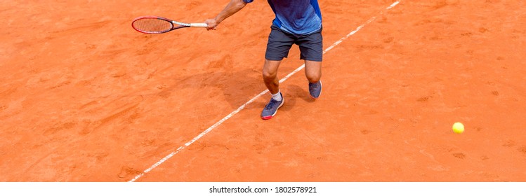 Male tennis player in action on the court on a sunny day. Background for tennis school banner. Individual sport concept