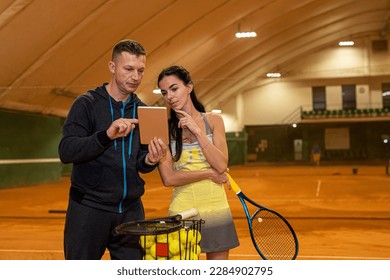 male tennis player coach instructs a new client before training. tennis concept. sports game - Powered by Shutterstock