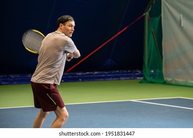 Male Tennis Player Concentrated On Game. Man Waits For The Pitch To Hit The Ball Back