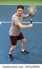 Male Tennis Player сoncentrated On Game. Man Waits For The Pitch To Hit The Ball Back