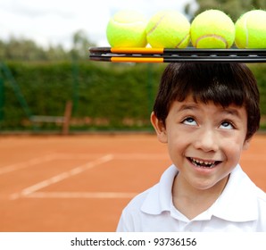 Male tennis player a racket and balls on top of his head