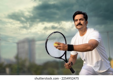  Male tennis player ready to serve at tennis court. - Powered by Shutterstock