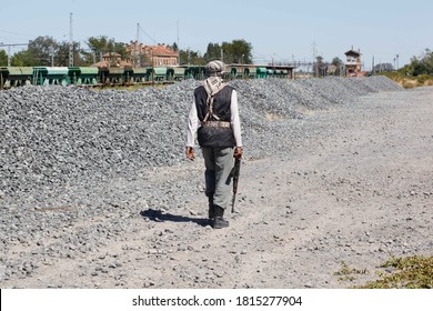 Male Terrorist Holding A Machine Gun